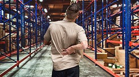 Man in warehouse with hurt back