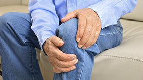 man in jeans with hurt knee